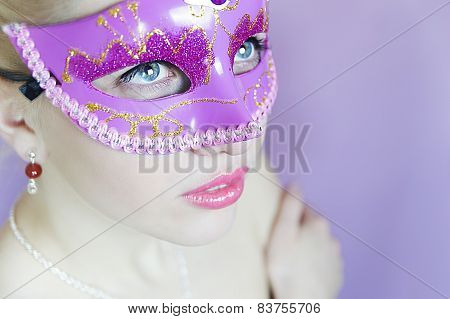 woman in pink carnival mask