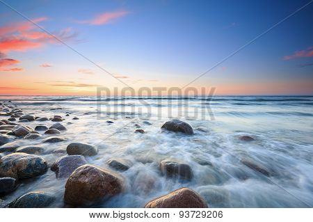 Sunset Over The Baltic Sea. The Pebbly Beach In Rozewie
