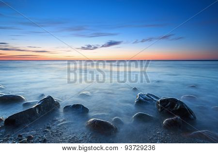 Sunset Over The Baltic Sea. The Pebbly Beach In Rozewie