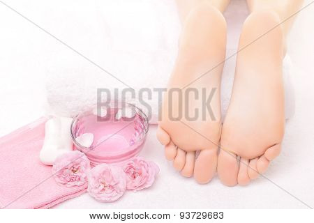 Foot massage in the spa with pink rose