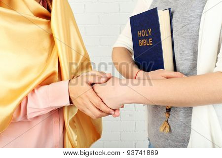 Two friends with different religions symbols