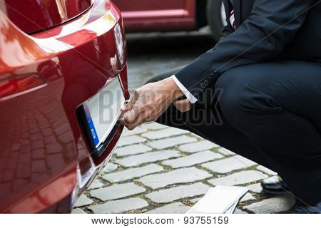 Man Holding Empty White Number Plate