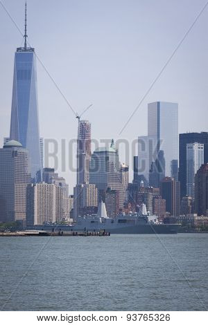 JERSEY CITY, NJ - MAY 26 2015: USS San Antonio (LPD 17) passes the Freedom Tower at One World Trade Center on the Upper New York Bay after departing Pier 92 at the end of Fleet Week NY 2015.