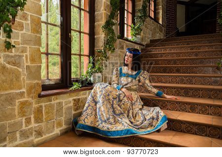 The girl in a medieval castle. Antique interiors.