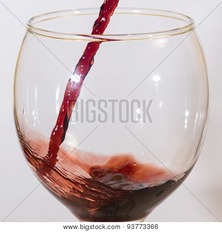 Red wine flow into glass macro