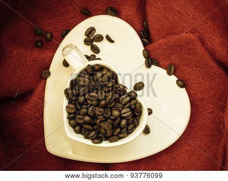 Heart Shaped Cup With Coffee Beans On Red