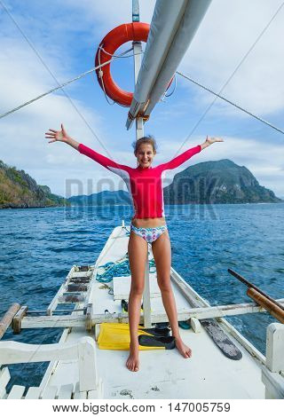 Beautiful young girl on a boat at a sunny summer day. Philippines