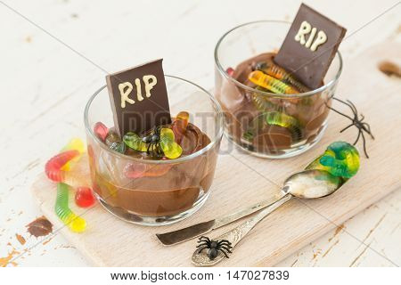 Chocolate mousse with gelly worm with halloween decorations