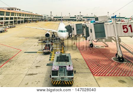 DONMUANG INTERNATIONAL AIRPORT BANGKOKTHAILAND - MAY 30 2016: Thai Smile Airways flight WE-283 load passengers and luggage before fly from Donmuang Interational Airport to Phuket Interational Airport.