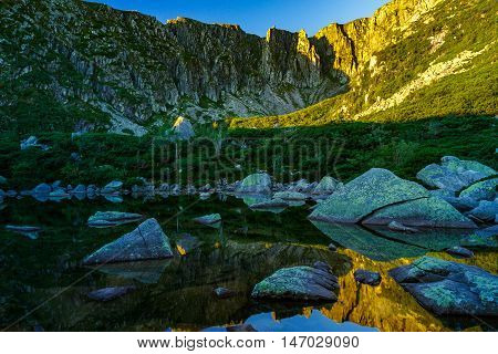 Small pond on Sniezne Kotly in Sudety Mountains view from below on ridge.