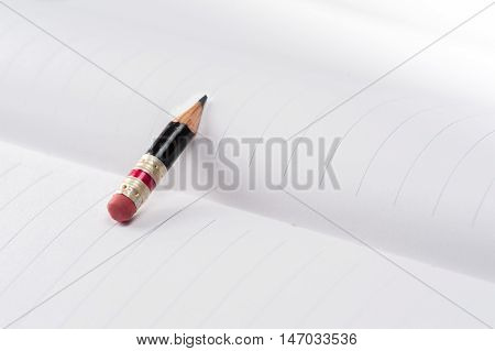 Black Pencil With Pink Eraser On A Paper