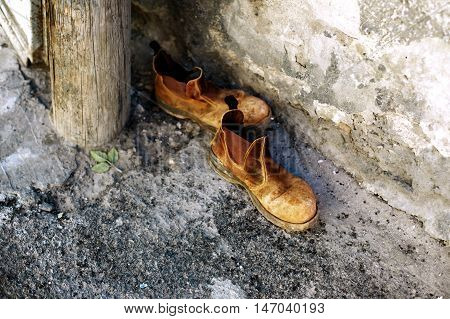 Old shoes on the street concept of travel or vagrancy