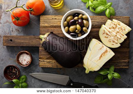 Cooking with eggplant, olives and tomatoes, ingredients for caponata