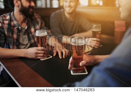 people, men, leisure, friendship and communication concept - close up of happy male friends drinking draft beer at bar or pub