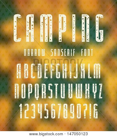 Narrow sanserif font with speckled texture. Bold face. White print on autumn blurred background