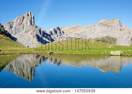 Peaks reflected in Ansabere Lake. Lescun Cirque. Aspe Valley, Pyrenees, France.