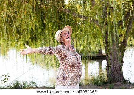 Elder happy woman outside in the nature