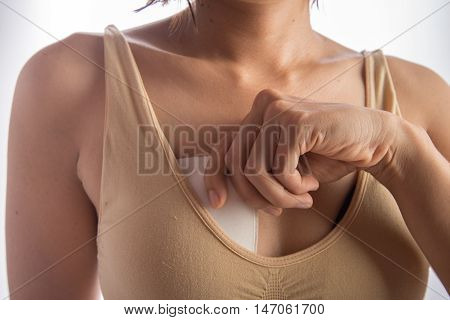 Woman using sponge bra accessories for breast extra size