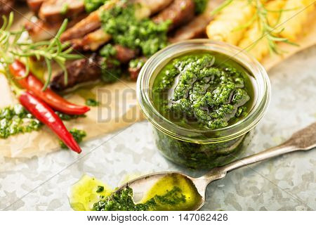 Green chimichurri parsley sauce with grilled steak