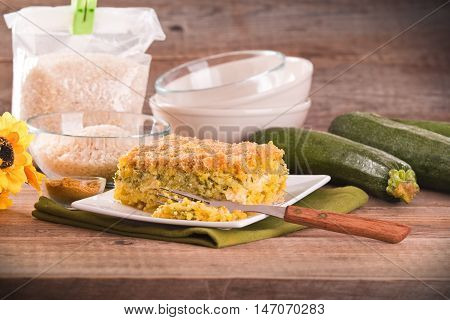 Rice timbale with zucchini on white dish.