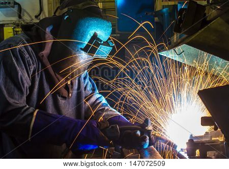 welder welding Industrial automotive part in factory