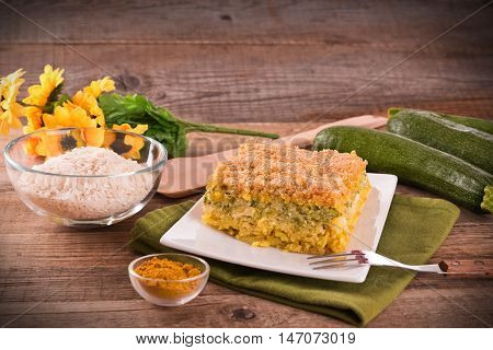 Rice timbale with zucchini on white dish.