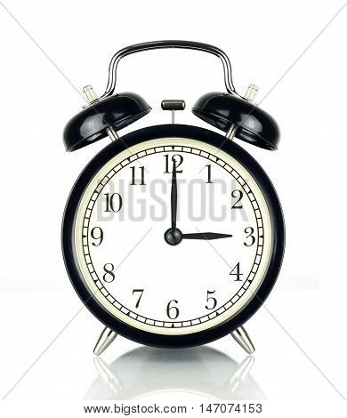 Alarm Clock isolated on white in black and white showing three o'clock.