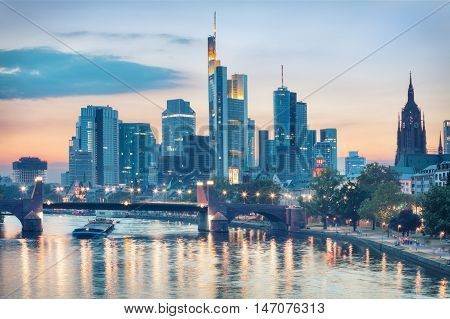 Evening view of Frankfurt city skyline over Alte Brucke bridge