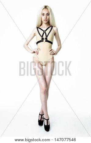 Blonde girl wearing bodysuit and black leather belt