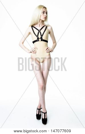 Blonde girl wearing bodysuit and black leather belt