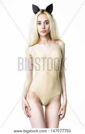 Blonde girl wearing bodysuit and black leather ears