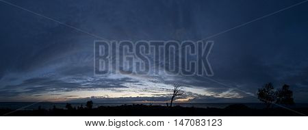 Small island in the Baltic Sea panorama. Single dead tree sunset and stormy night on the beach. Mohni Estonia Europe.