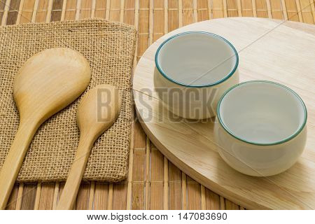 Trencher and cups on the wooden background