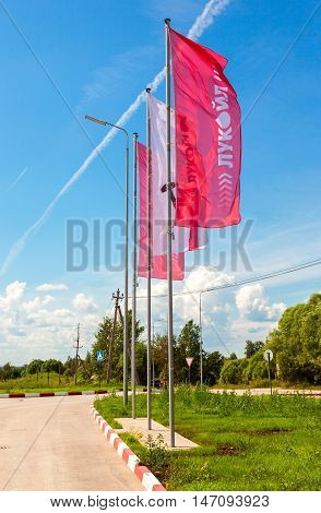 BOROVICHI RUSSIA - JUNE 26 2016: The flags of the oil company Lukoil on the gas station. Lukoil is one of the largest russian oil companies