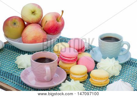 Still life of served coffee cups macaroon cookies marshmallows and apples