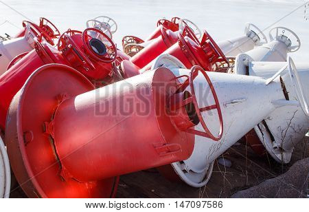 unnavigable period. red and white buoys on the shore in the winter. closeup