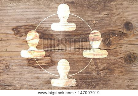 Organigram with heads on brown wooden background