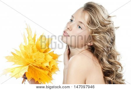 closeup beauty portrait of attractive caucasian woman blond isolated on white studio shot lips skin face hair head and shoulders blue eyes hand holding yellow marple autumn leaves