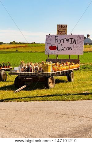 Ronks PA - September 12 2016: The Pumpkin Wagon with farm fresh pumpkins and squash parked in a field along a road.