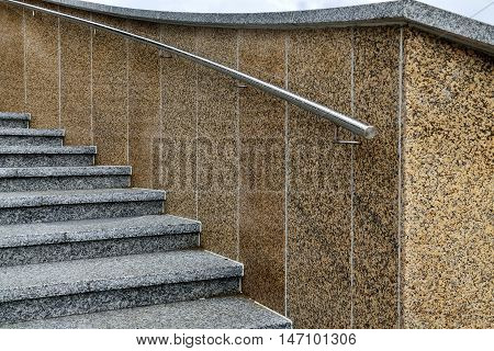 Staircase with marble steps and steel railings on the promenade