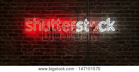 SAN FRANCISCO, CA - SEPTEMBER 2016: Neon sign of the Shutterstock logo glowing against an exposed brick wall in Shutterstock's San Francisco office.