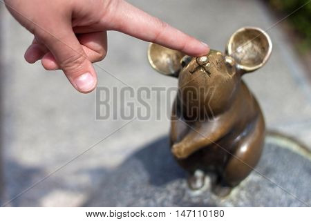 LITHUANIA, KLAIPEDA - MAY 25, 2014: Sculpture Wonderful little mouse is oldtown Klaipeda. Lithuania. One of the most famous sculptures in the city.