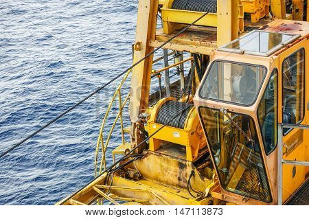 Cabin crane boom structure and metal sling on blue sky and sea background