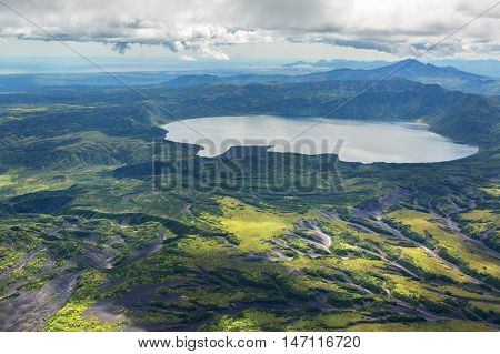 Crater Karymsky Lake. Kronotsky Nature Reserve on Kamchatka Peninsula. View from helicopter.