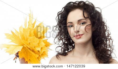 closeup portrait of attractive  caucasian smiling woman brunette isolated on white studio shot lips  face hair head and shoulders looking at camera hand holding yellow marple autumn leaves