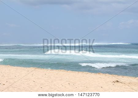 beatiful layered waves blowing to white beach in sunny day
