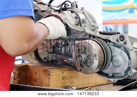Hands of disassembly kit motorcycle in repair service. Automotive engine disassembly kit motorcycle.