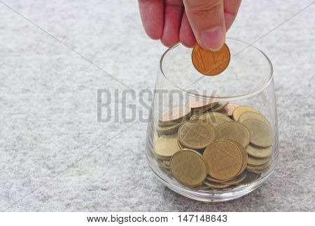 Saving Money Concept, Money In Hand And Money In Glass
