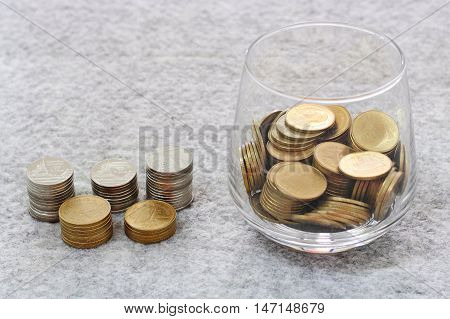 Money In The Glass With Coin Stack Growing