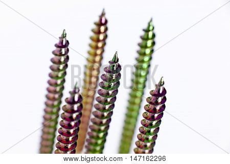 Colorful metal screws isolated on white background